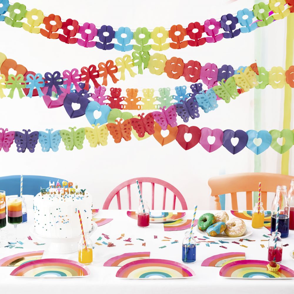 rainbow themed table decorations with colorful paper garland banner