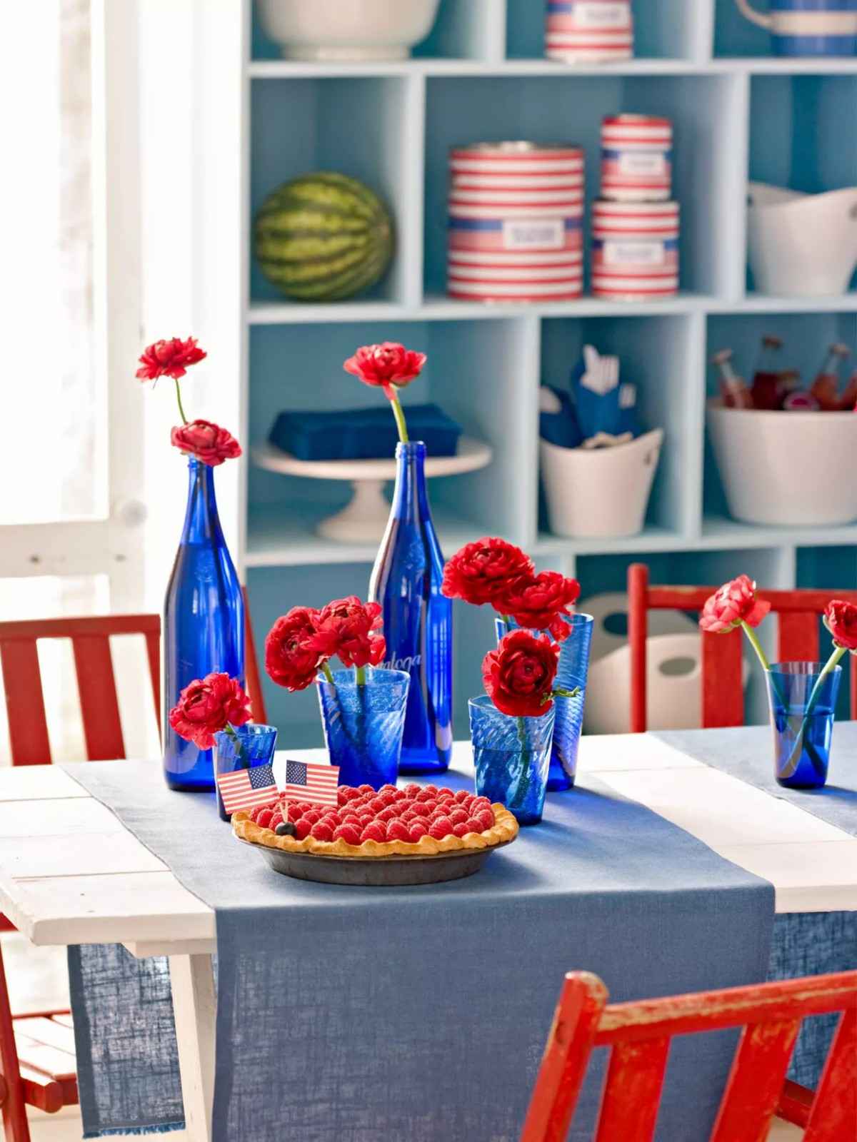4th of July Party blue glassware centerpiece with red flowers