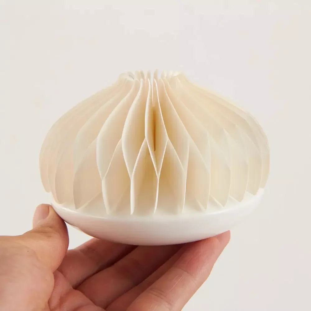 Final MUJI-branded paper diffuser product, showing the expanded honeycomb shade on its base.