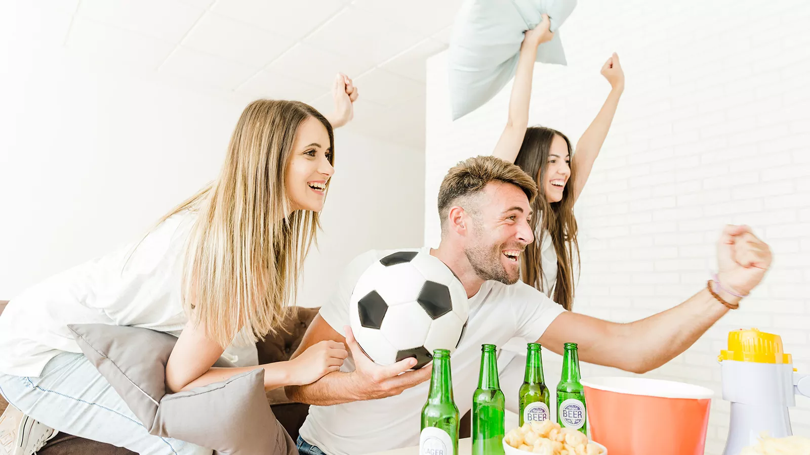 friends celebrating watching football home