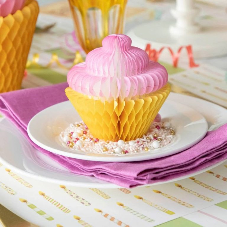 Honeycomb Medium Cupcake on top of a plate surrounded by sprinkles, on a fun, birthday themed table setting