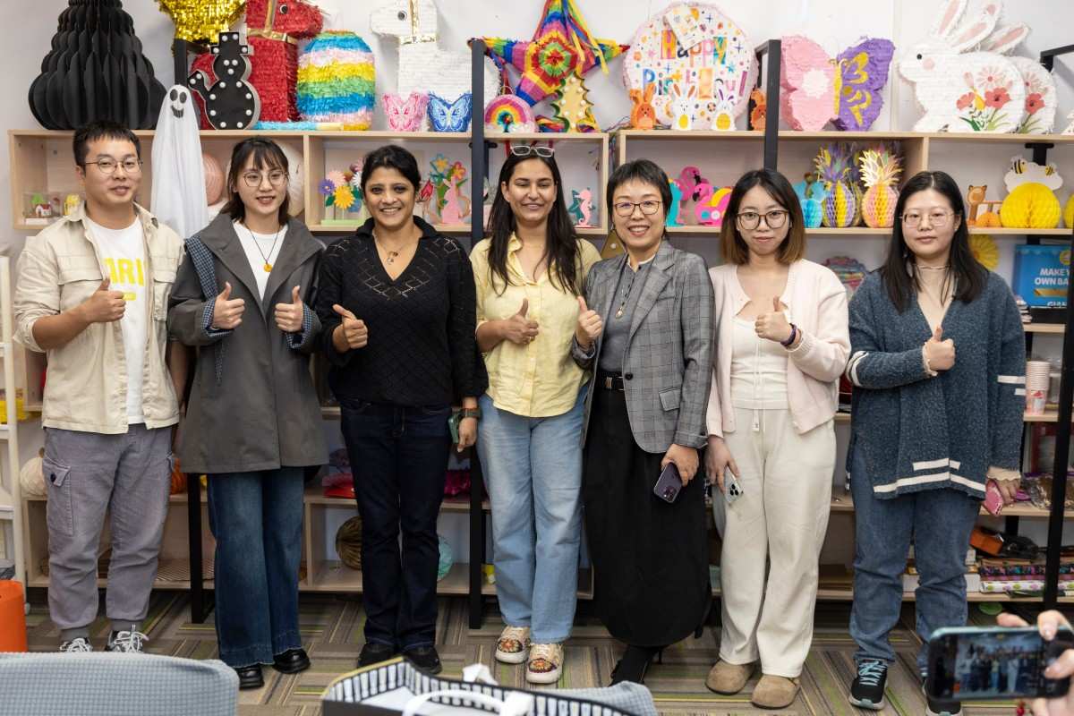 Sunbeauty Team celebrating in a craft workshop with vibrant pinata and paper animal decorations