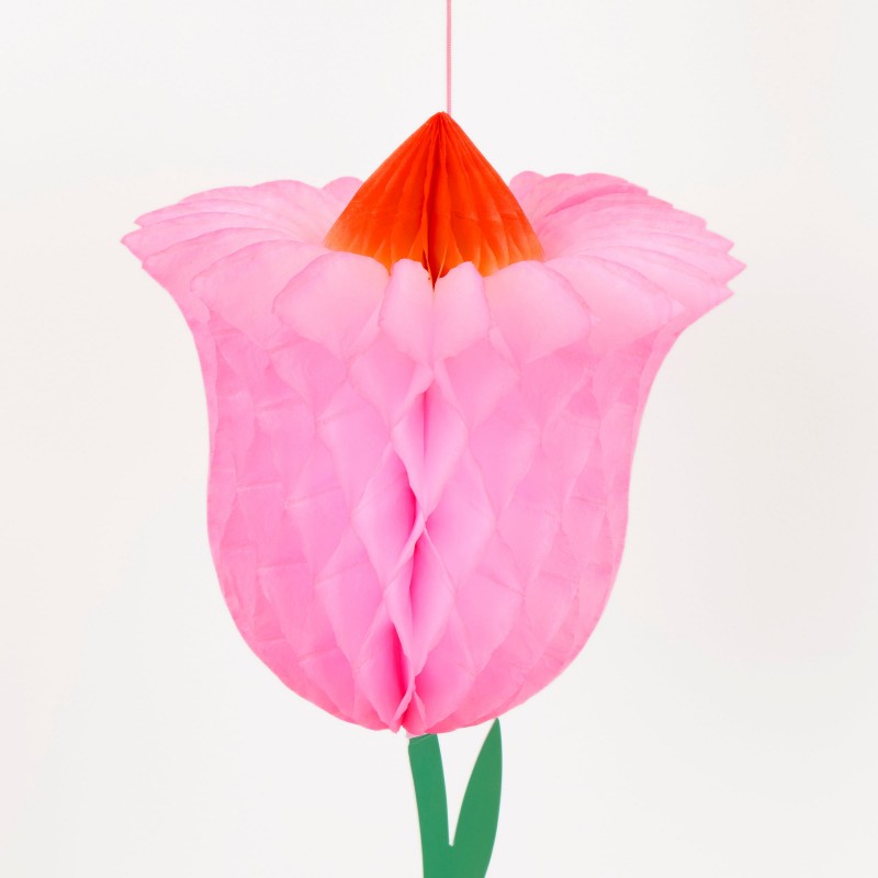 Close-up of a pink honeycomb paper tulip decoration