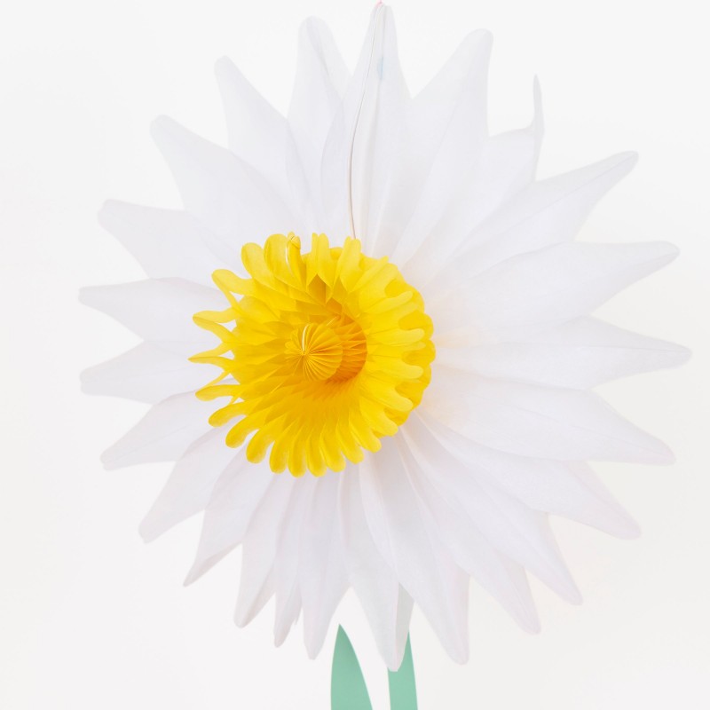 Close-up of a white honeycomb paper daisy decoration