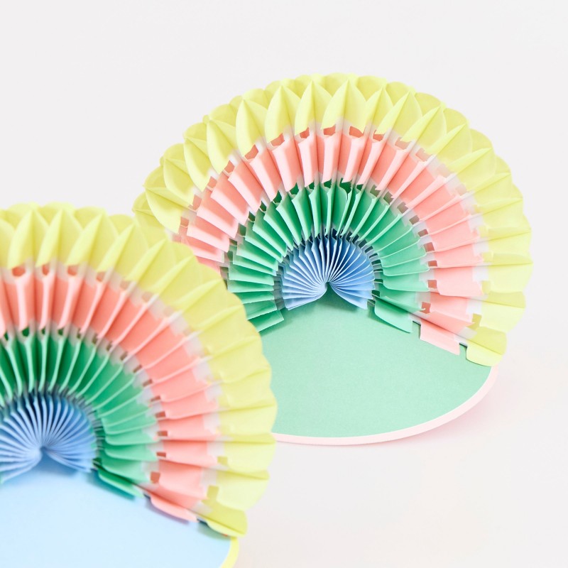 Close-up of pastel rainbow honeycomb party fans