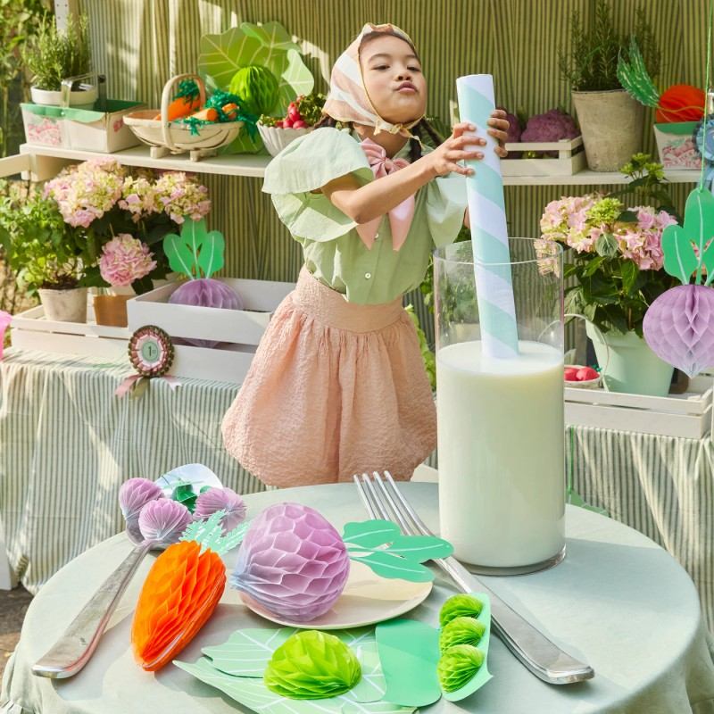 Kids pretend play garden market with giant vegetable paper decorations.