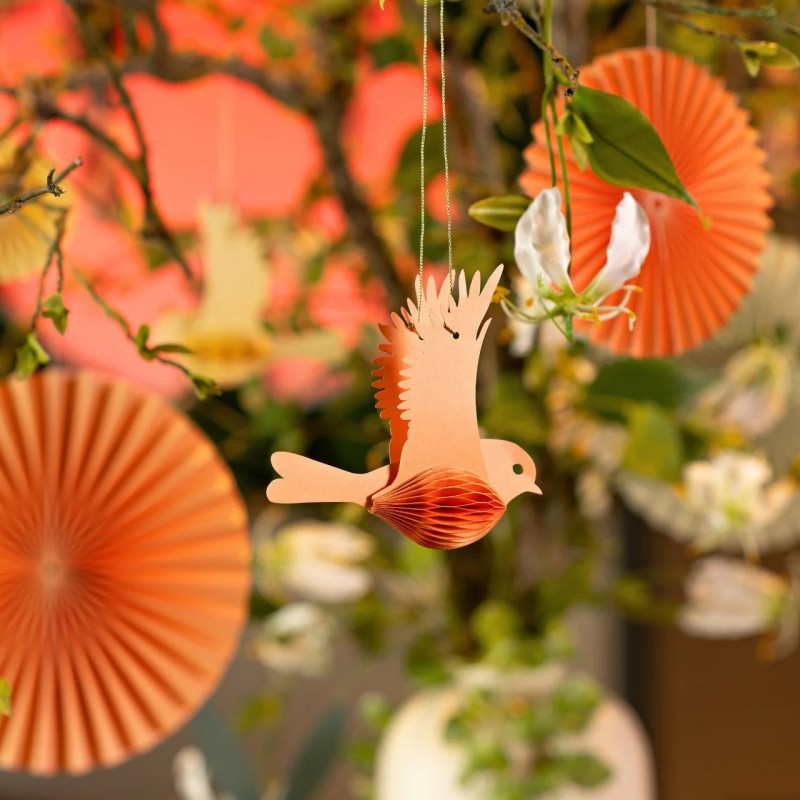 Orange honeycomb bird decoration in a party setting