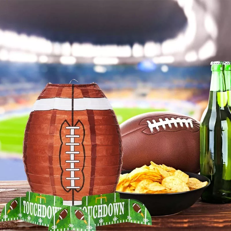 Football paper lantern table decor, super bowl watch party table centerpiece with chips, beer and football props