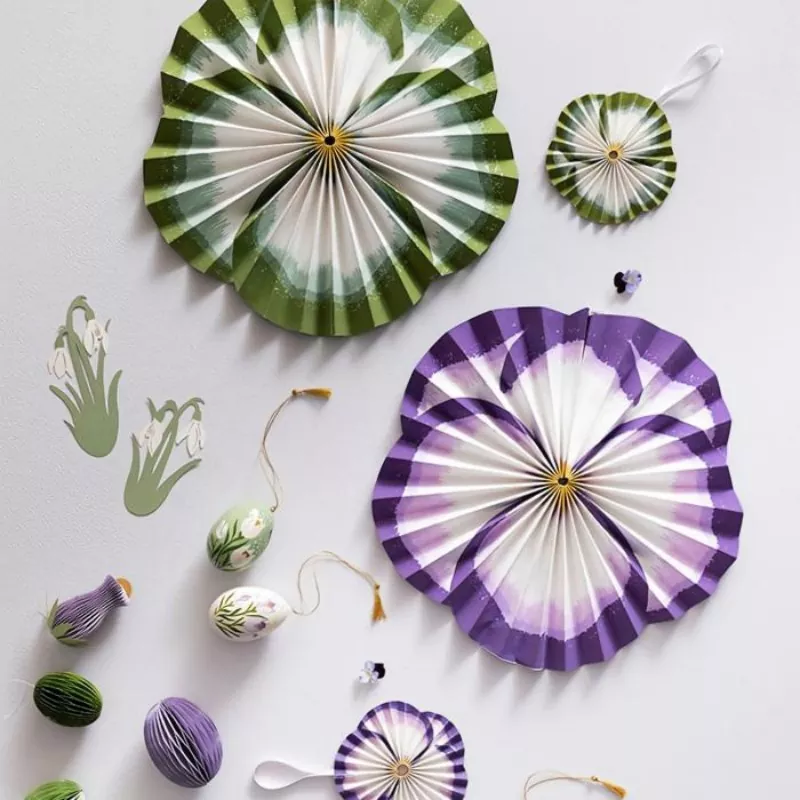Green purple pansy paper fan decorations Easter spring flat lay styling