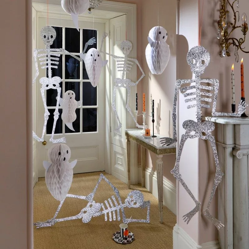 Halloween interior styling, white honeycomb ghost hanging decorations with glitter skeleton cutouts, spooky home party decor