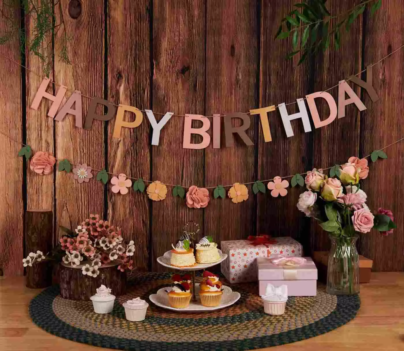 Earth‑tone floral birthday banner, vintage wooden backdrop dessert table