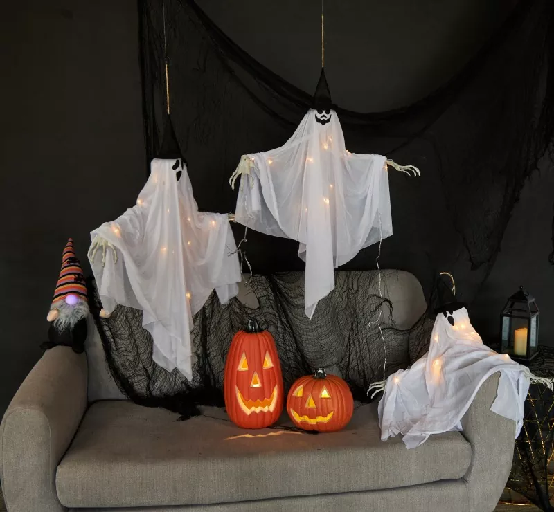 Halloween living room setup with LED ghost hanging ornaments