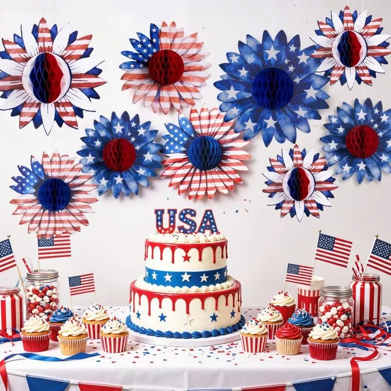 Patriotic sunflower honeycomb paper flower hanging decorations above 4th of July dessert table with USA cake, cupcakes and mini US flags