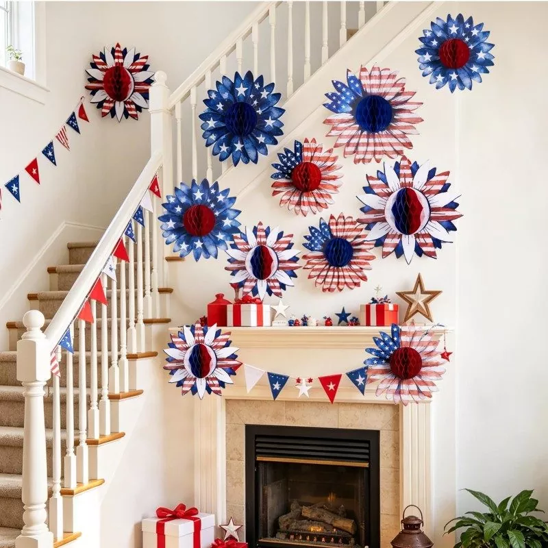 Patriotic sunflower honeycomb paper flowers decorating indoor staircase and fireplace mantel with red white blue bunting and gift boxes