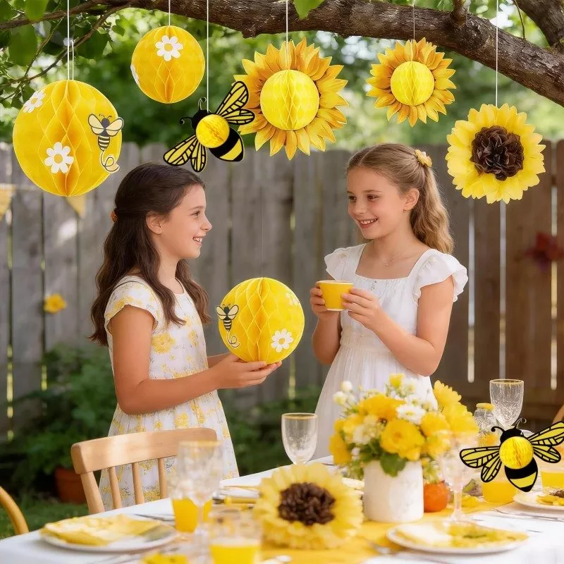 Sunflower bee honeycomb paper hangings, outdoor backyard kids garden party lifestyle shot